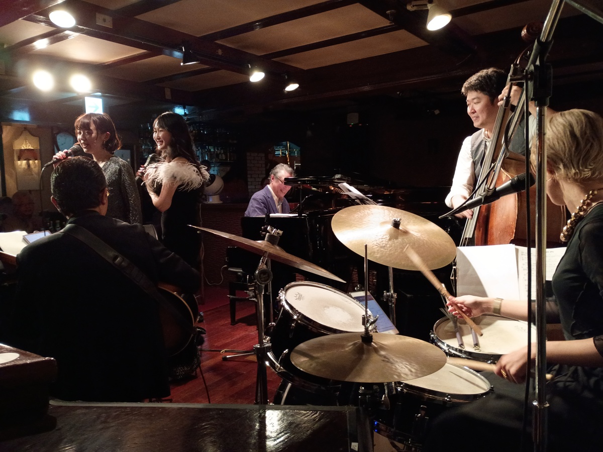 Figure 2: Toshimitsukuni Vocal Matsuri live concert with Hibiki Sato and Eri Yazaki on vocals, Rena Toshimitu on drums/vocals, Mitsukuni Tanabe on guitar, Hideaki Yoshioka on piano, and Yosuke Terao on bass (October 2025)